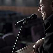 AAFQ001746 - Businessman Talking Into Microphone